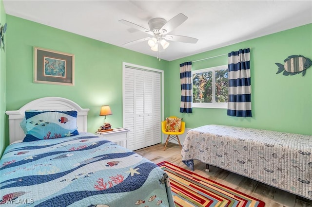 bedroom featuring ceiling fan, a closet, and wood-type flooring