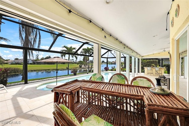 sunroom featuring a water view and vaulted ceiling