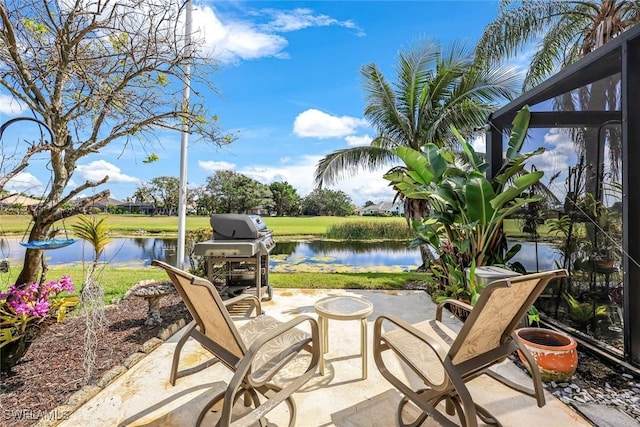 view of patio featuring area for grilling and a water view