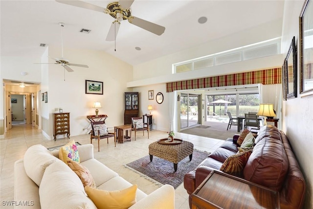 living area featuring high vaulted ceiling, visible vents, and light tile patterned floors