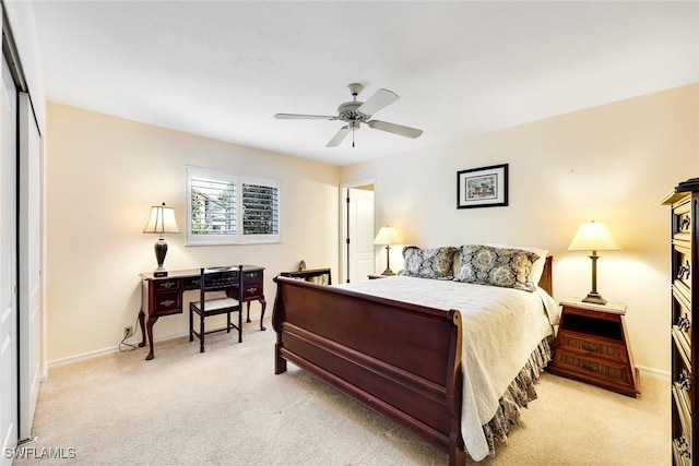 bedroom featuring light colored carpet, ceiling fan, and baseboards