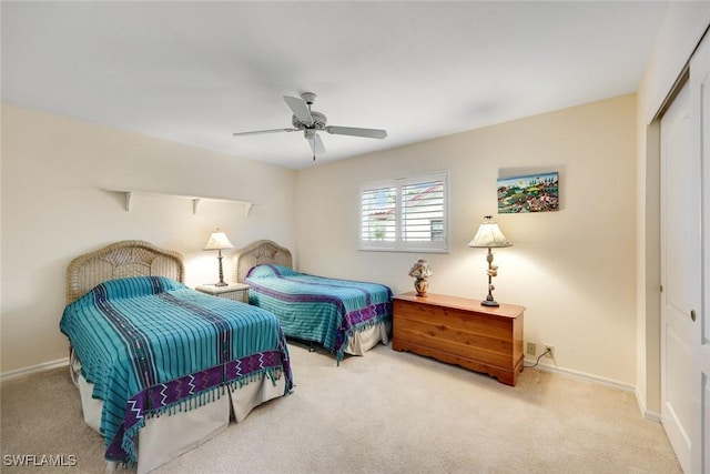 bedroom featuring ceiling fan, baseboards, a closet, and carpet flooring