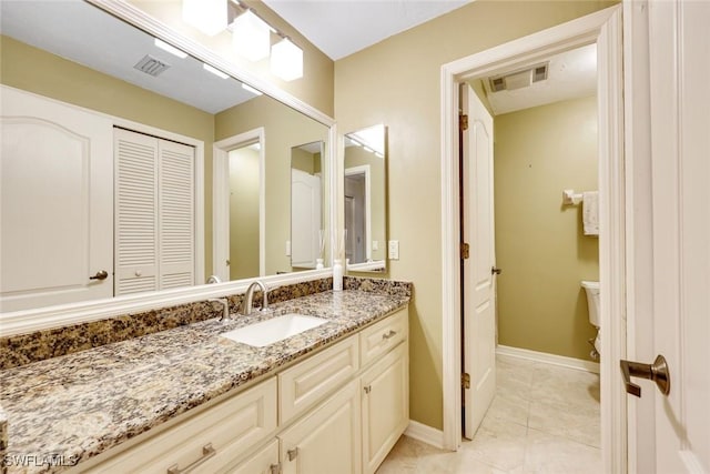 bathroom with toilet, baseboards, visible vents, and vanity