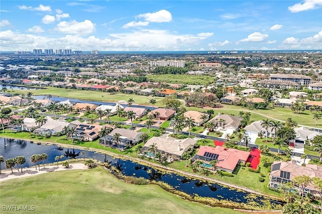 bird's eye view with a water view, a residential view, and golf course view