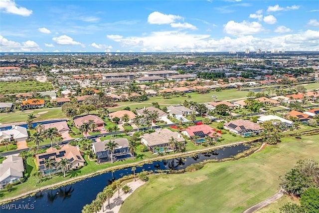 drone / aerial view with a water view and a residential view