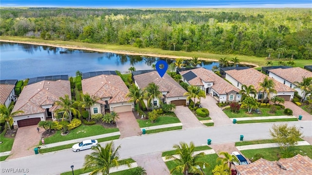 bird's eye view with a residential view, a water view, and a view of trees