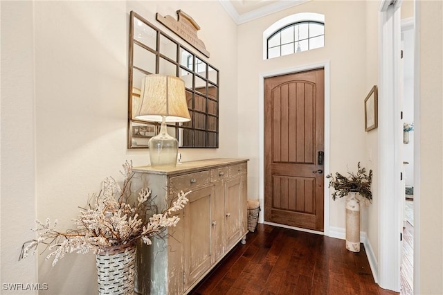 foyer entrance with ornamental molding, dark wood-style flooring, and baseboards