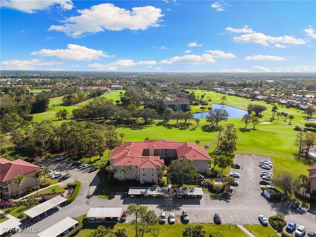 aerial view featuring golf course view, a water view, and a residential view