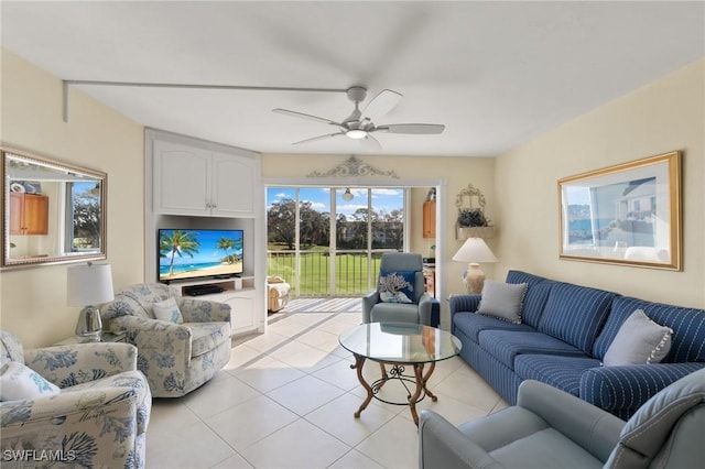 living area with ceiling fan and light tile patterned floors