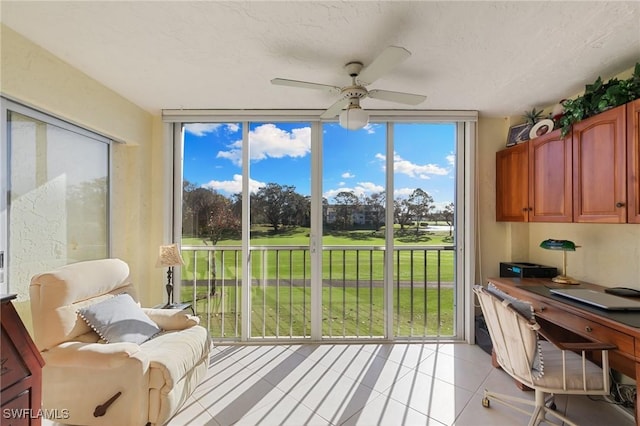 sunroom / solarium with a healthy amount of sunlight and a ceiling fan