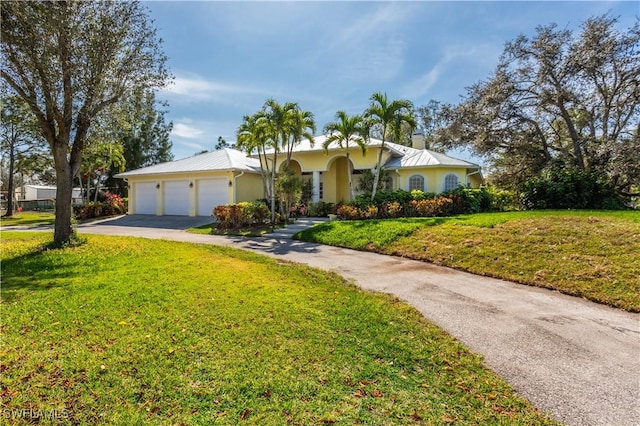 view of front of home featuring a garage and a front yard