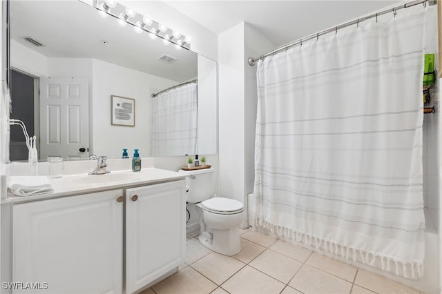 full bathroom featuring tile patterned floors, toilet, vanity, and shower / tub combo