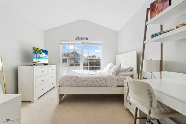 carpeted bedroom with lofted ceiling