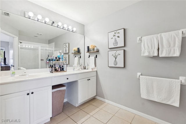 bathroom with tile patterned floors, vanity, and a shower with shower door