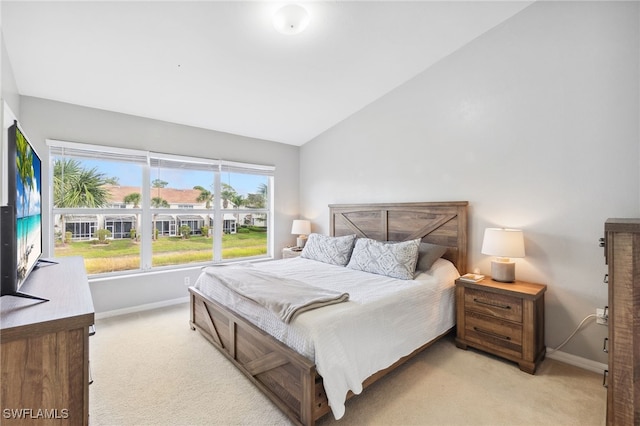 carpeted bedroom with vaulted ceiling