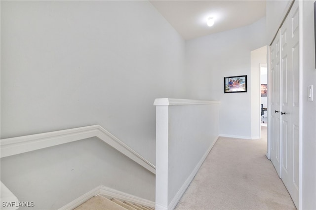 hallway featuring light colored carpet