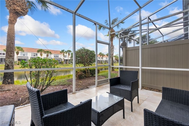 sunroom featuring a water view and a wealth of natural light