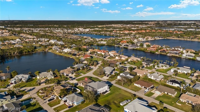 drone / aerial view featuring a water view and a residential view