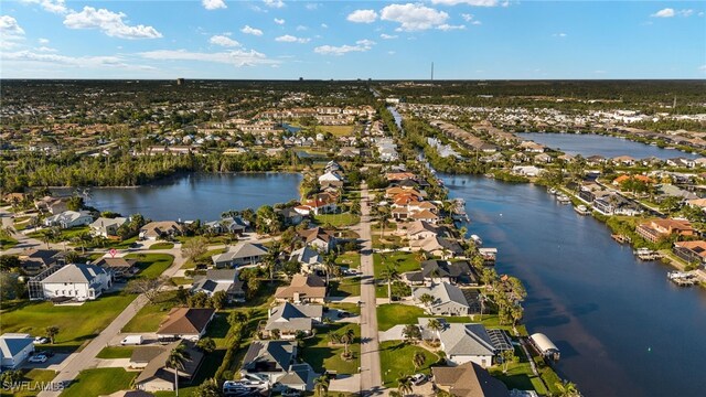 drone / aerial view with a residential view and a water view