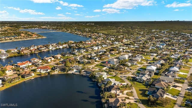 birds eye view of property with a residential view and a water view