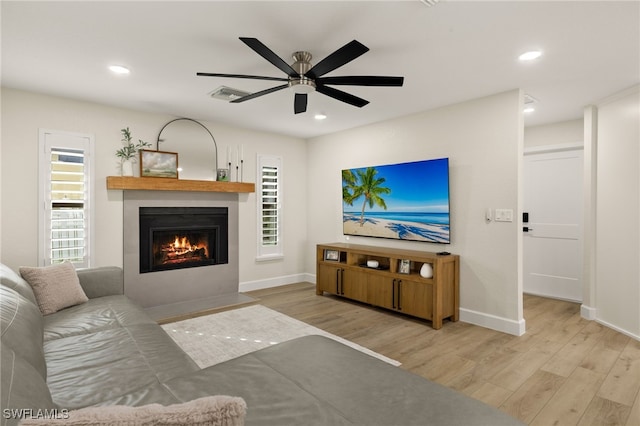 living area featuring recessed lighting, visible vents, and wood finished floors