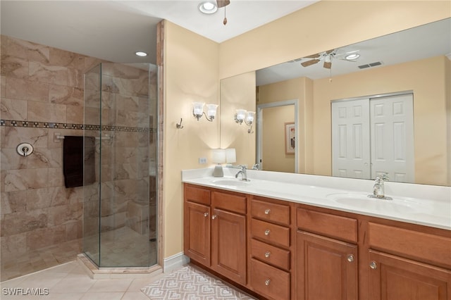 full bathroom featuring ceiling fan, double vanity, a sink, and visible vents