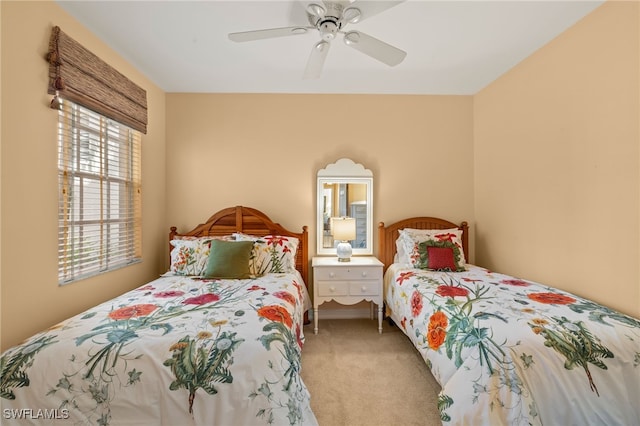 bedroom featuring light carpet and ceiling fan