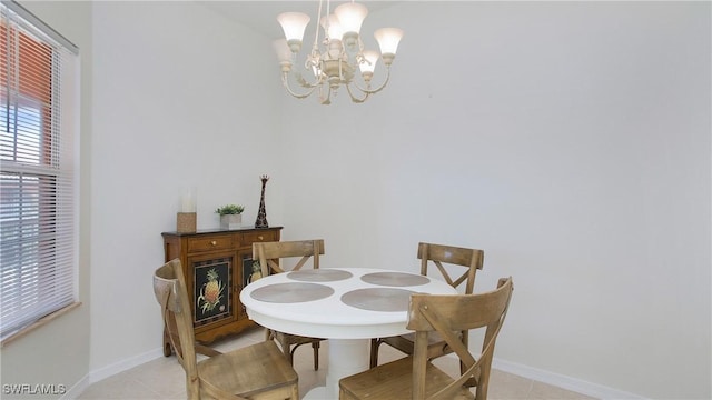 dining room featuring a chandelier, light tile patterned flooring, and baseboards