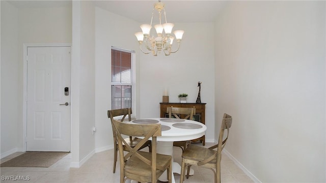 dining room with light tile patterned floors, baseboards, and an inviting chandelier