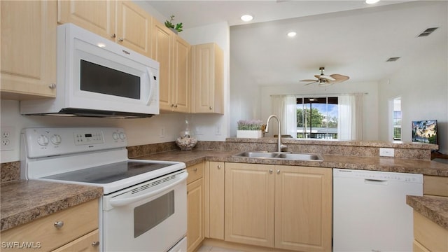 kitchen with light brown cabinetry, white appliances, a sink, and visible vents