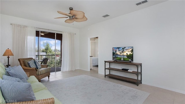 tiled living room featuring visible vents and ceiling fan