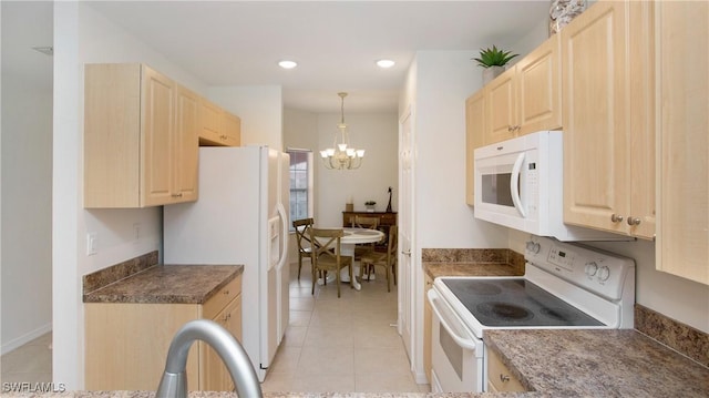 kitchen with a chandelier, white appliances, light brown cabinets, and light tile patterned floors