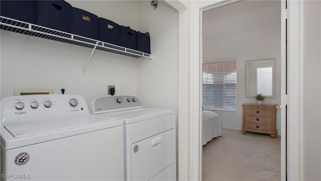 washroom with laundry area, washer and clothes dryer, and light colored carpet