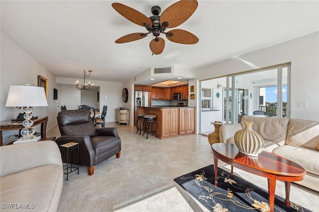 living area featuring ceiling fan with notable chandelier, visible vents, and light tile patterned floors