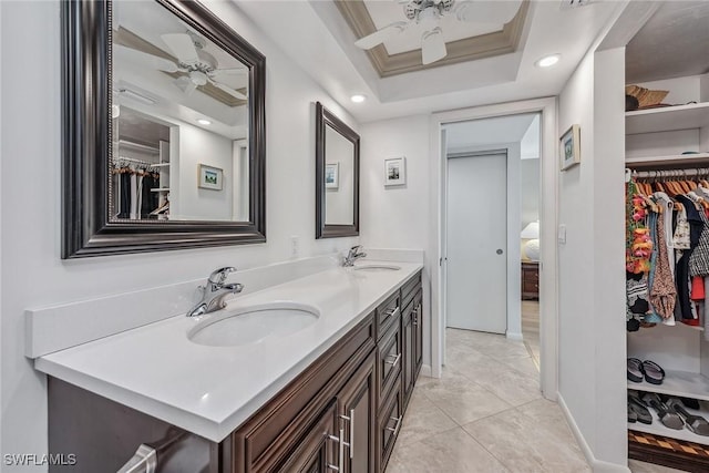 bathroom featuring a sink, a ceiling fan, ornamental molding, and double vanity