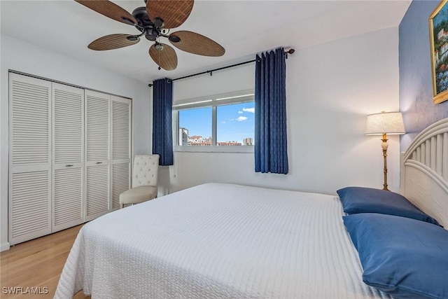 bedroom with a closet, a ceiling fan, and light wood finished floors