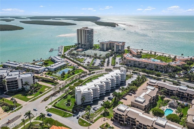 birds eye view of property featuring a water view and a city view