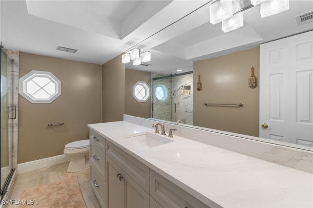 bathroom featuring a stall shower, visible vents, baseboards, toilet, and vanity