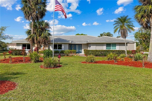 ranch-style house featuring a front lawn and stucco siding