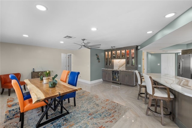 dining space featuring wine cooler, recessed lighting, visible vents, wet bar, and baseboards