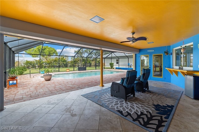 view of patio featuring a lanai, a ceiling fan, and an outdoor pool