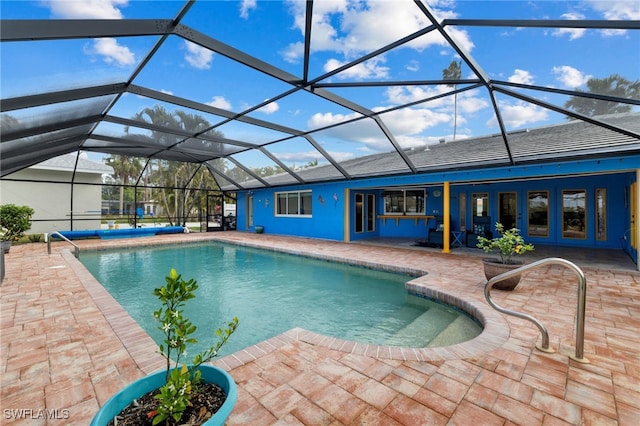 pool with glass enclosure, french doors, and a patio area