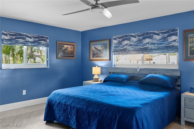 bedroom with ceiling fan and baseboards