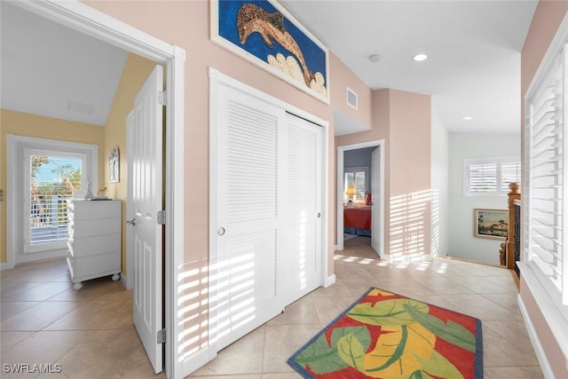 interior space featuring light tile patterned flooring, plenty of natural light, and visible vents