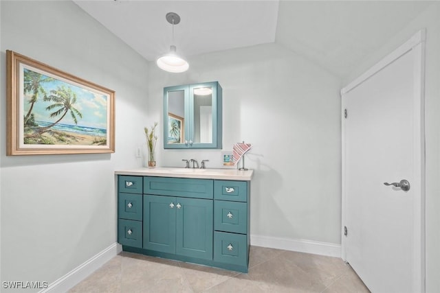 bathroom with vanity, baseboards, and tile patterned floors