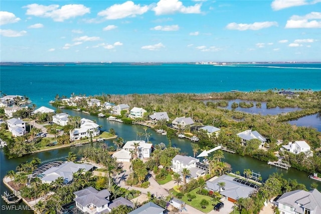 birds eye view of property with a water view and a residential view