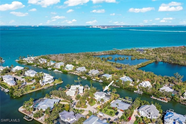 drone / aerial view featuring a water view and a residential view