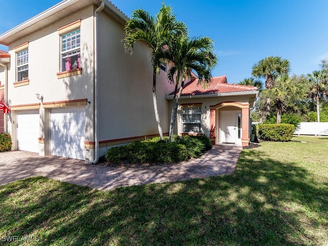 mediterranean / spanish home with a garage and a front yard