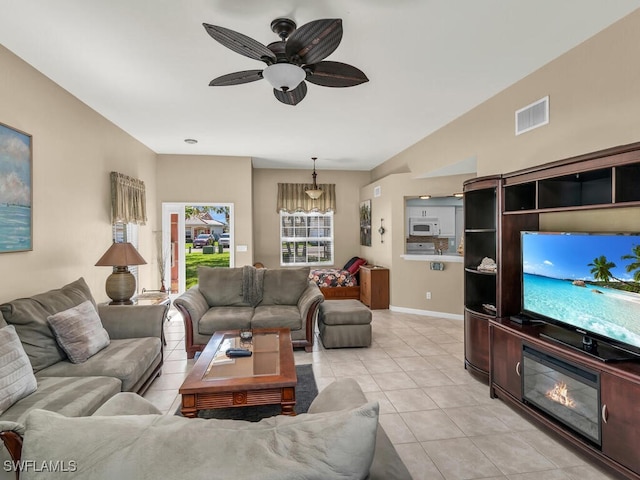 living room with ceiling fan and light tile patterned flooring