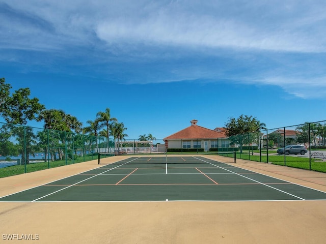 view of tennis court featuring basketball hoop